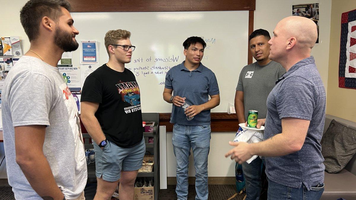 Picture of 5 people standing inside the Veteran Resource Room